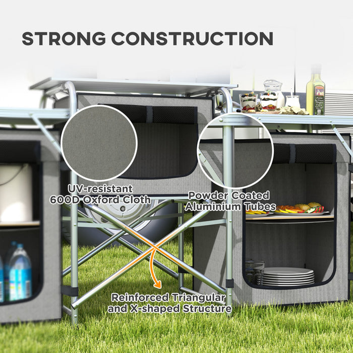 Outsunny Folding Camping Kitchen Table with Storage, Aluminum Portable Camping Table with 3 Fabric Cupboards, Windshield, Light Stand, Carrying Bag for BBQ, RV, Picnic, Grey